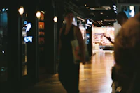 a group of people walking down a hallway in a shopping mall