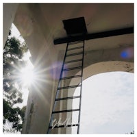 a ladder leading up to a sunlit archway
