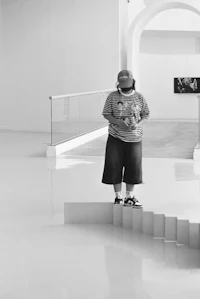 a man standing on a set of stairs in a museum