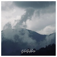 an image of a mountain with clouds in the background