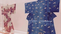 japanese kimonos on display in a glass case