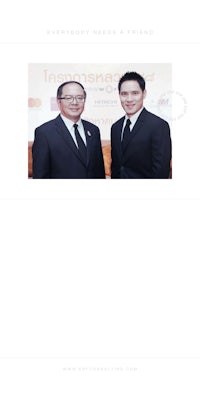 two men in suits standing next to each other