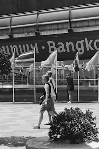 a group of people walking in front of a building