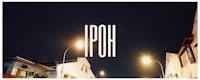 the word iph is written on a street at night