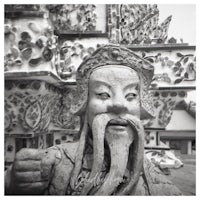 a statue of an asian man with a beard