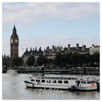 a boat on the river thames with big ben in the background