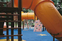 a yellow slide in a playground
