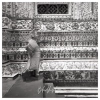 black and white photo of a statue in front of a building