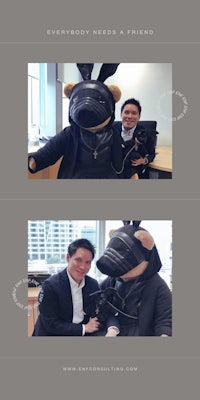a man in a suit is posing with a stuffed animal