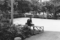 a man sitting on a bench at a skate park