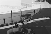 a black and white photo of a rickshaw parked on a street