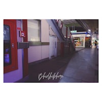 a picture of a train station with stairs and a sign