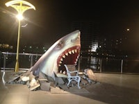 a statue of a shark with its mouth open