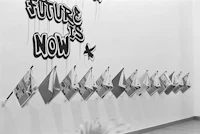 a black and white photo of a wall with flags hanging on it