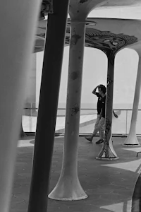 a skateboarder is riding a skateboard under a structure