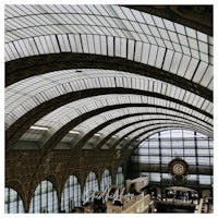 the ceiling of a train station with a clock