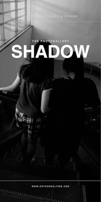 shadow - a black and white photo of two people walking down an escalator
