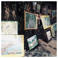a group of paintings on display in front of a building