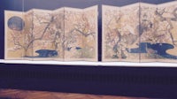 a set of screens with a painting on them