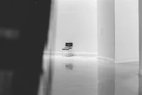 a black and white photo of a chair in an empty room