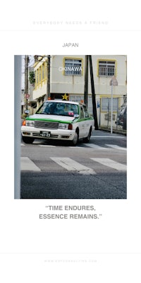 an image of a japanese taxi driving down the street