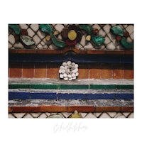 an image of a tiled wall with a bird on it
