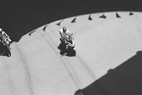 a black and white photo of a group of people riding motorcycles