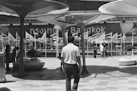 black and white photo of a group of people in a plaza