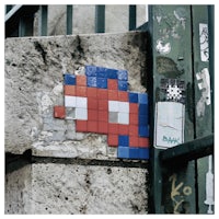 a red, blue, and white pixelated image on the side of a wall
