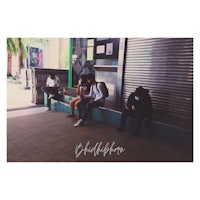 a group of people sitting on a bench