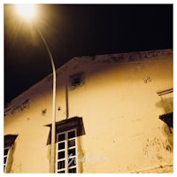 an old building at night with a street light
