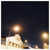 a street scene with street lights and buildings at night