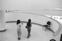 two women standing in a circular room
