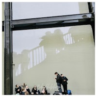 a group of people sitting on the steps of a building