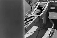 a black and white photo of an escalator