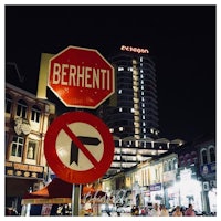 a stop sign in front of a building at night
