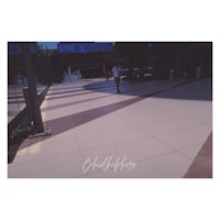 a man walking down a sidewalk in a city