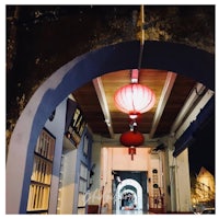 chinese lanterns hanging in an archway at night