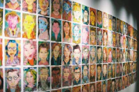 a wall of faces on a wall